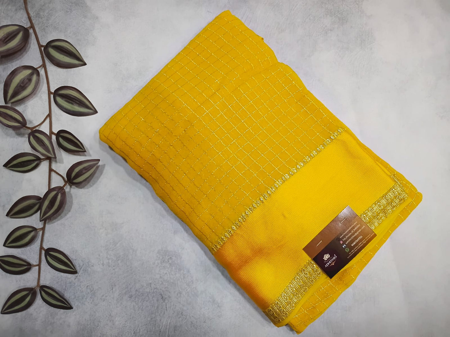 Yellow fabric with a textured pattern on a gray background
